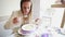 Beautiful young woman eating soup in restaurant