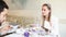 Beautiful young woman eating soup in restaurant