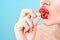 Beautiful young woman eating strawberries. Image illustrates diet, healthy food, berries and fruits.