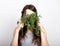 Beautiful young woman eating an vegetables. holding dill and parsley. healthy food - healthy body concept