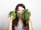 Beautiful young woman eating an vegetables. holding dill and parsley. healthy food - healthy body concept