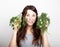 Beautiful young woman eating an vegetables. holding dill and parsley. healthy food - healthy body concept