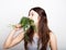 Beautiful young woman eating an vegetables. holding dill and parsley. healthy food - healthy body concept