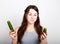 Beautiful young woman eating an vegetables. selection, small or big cucumber. healthy food - strong teeth concept