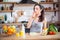 Beautiful young woman eats vegetable salad. The girl with pleasure puts a piece of fresh tomato in her mouth