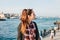 Beautiful young woman enjoys beautiful views in Istanbul. People, city buildings and ships sailing along the Bosphorus