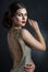 Beautiful young woman in an evening dress crystal. Perfect beauty, red lips, bright makeup. Twinkling sparkling stones on dress