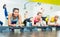 Beautiful young woman exercising a plank variation during group workout