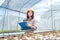 Beautiful young woman farmer researching hydroponics, organic vegetables