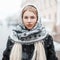 Beautiful young woman in a fashionable scarf on a winter day