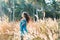 Beautiful young woman on a field at sunset