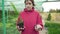 Beautiful young woman florist - business owner is holding a growing green plant and a dry tree branch. Life and death in