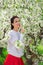 beautiful young woman by the flowering tree. natural cosmetics and perfumes.