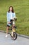 A beautiful young woman folds up and unfolds a bicycle. Convenient folding bike for travel and transportation