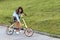 A beautiful young woman folds up and unfolds a bicycle. Convenient folding bike for travel and transportation