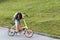 A beautiful young woman folds up and unfolds a bicycle. Convenient folding bike for travel and transportation