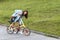 A beautiful young woman folds up and unfolds a bicycle. Convenient folding bike for travel and transportation