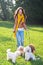 Beautiful young woman with four poodles