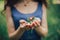 Beautiful young woman, in the garden with blooming trees. Springtime, hands care