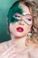 Beautiful young woman in a green mysterious venetian mask a new year carnival, Christmas masquerade, a dance club, secret