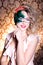 Beautiful young woman in a green mysterious venetian mask a new year carnival, Christmas masquerade, a dance club, secret nigh