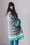 Beautiful young woman in grey long knitted cardigan