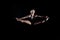 Beautiful young woman gymnast leaping splits