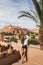 Beautiful young woman happy to travel in Morocco. Ait-Ben-Haddou on background