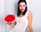 Beautiful young woman holding and eating slice of ripe red fresh juicy tasty watermelon