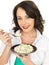 Beautiful Young Woman Holding a Plate of Italian Style Risotto