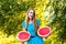Beautiful young woman holding two halfs of watermelon