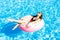 Beautiful young woman on inflatable donut in swimming pool