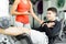 Beautiful young woman instructing a young man in the gym