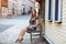 Beautiful young woman with long hairs in summer dress going for a walk in German city. Happy girl enjoying walking in