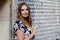 Beautiful young woman with long hairs in summer dress going for a walk in German city. Happy girl enjoying walking in