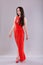 Beautiful young woman in long red dress