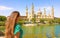 Beautiful young woman looking at Cathedral Basilica of Our Lady of the Pillar  in Zaragoza, Spain