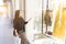 Beautiful young woman looking store showcase in love with clothes, pointing glass smiling and happy at the shopping center