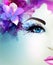 Beautiful young woman looks straight. Light blooming orchid decorated abstract hair.