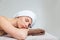 Beautiful young woman lying with eyes closed in spa salon