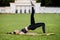 Beautiful young woman lying on a yellow mattress doing pilates or yoga, shoulder bridge exercises