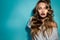 beautiful young woman with magenta lips and perfect curly hairstyle looking at the camera in studio