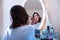 A beautiful young woman at a makeup table