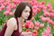 Beautiful young woman next to pink tulip garden