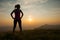 Beautiful young woman observing sunset after running on a mountian