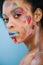 beautiful young woman with paint strokes on face