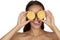 Beautiful young woman with perfect healthy skin and long brown hair day makeup bare shoulders holding orange lemon grapefruit