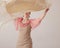 Beautiful young woman in a pink and beige dress dancing flamenco with a shawl. A scarf flutters in her hands