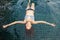 Beautiful young woman in the pool, shot from top