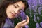 Beautiful young woman portrait on lavender flowers background, face closeup